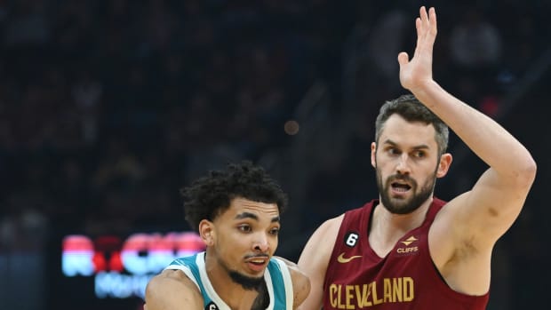 Charlotte Hornets guard James Bouknight (2) drives to the basket against Cleveland Cavaliers forward Kevin Love (0) during the first half at Rocket Mortgage FieldHouse.